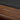 Legacy Billiards Caney Pool Table in Nutmeg Finish with Black Cloth - Room Shot - Logo Rail Closeup